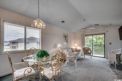Dining space with vaulted ceiling, ceiling fan wit