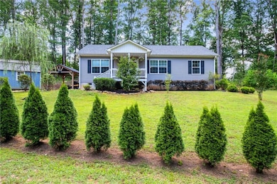View of front of home featuring a front yard and a porch