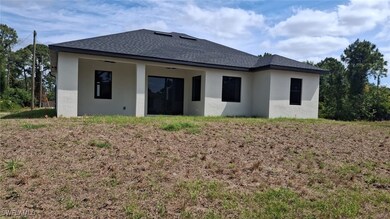 Rear view of property with roof with shingles and