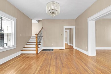 Foyer featuring a chandelier, stairs, and light wood-style flooring