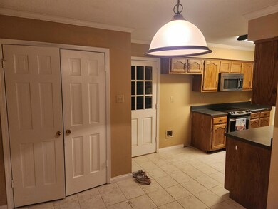 Kitchen with crown molding, pendant lighting, ligh