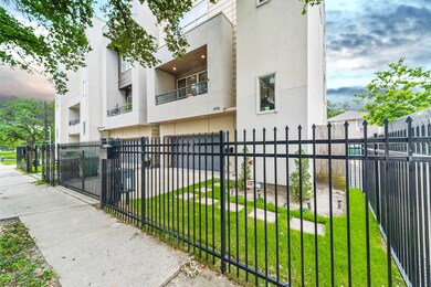 This home features a fenced front yard with grass