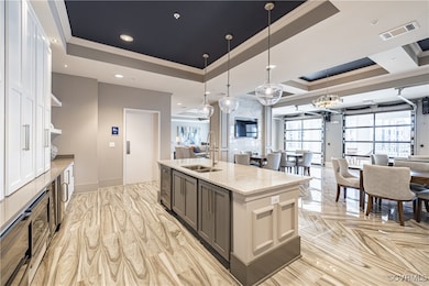 Kitchen with a kitchen island with sink, light sto