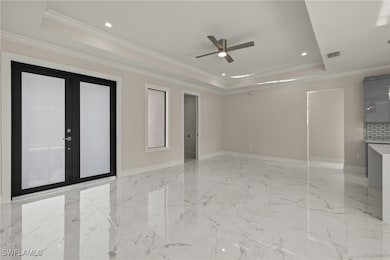 Unfurnished room with a raised ceiling, a ceiling
