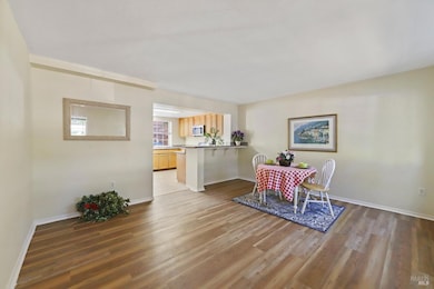 Spacious den with light from both kitchen and dual front windows