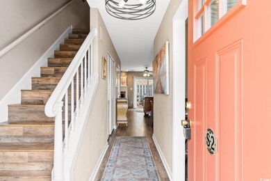 Entrance foyer featuring ceiling fan and hardwood 