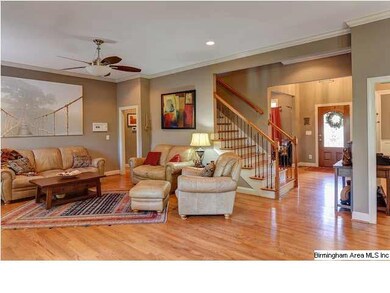 Beautiful oak staircase is open to family room and
