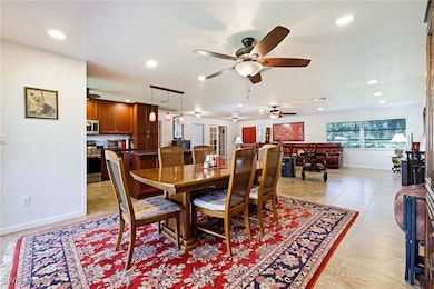 Dining room with a ceiling fan, recessed lighting,