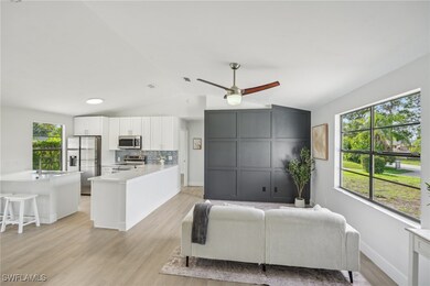Living room featuring vaulted ceiling, plenty of n