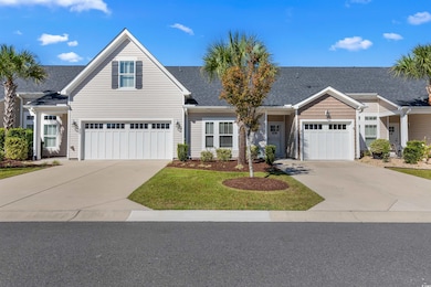 Traditional home featuring concrete driveway, a front lawn, and roof with shingles