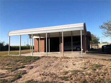 Back of house featuring brick siding