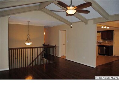 Hardwood floors and beam ceiling in the living roo