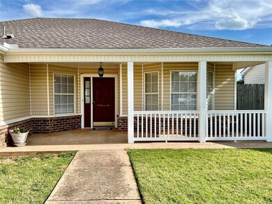 Doorway to property with a porch and a yard