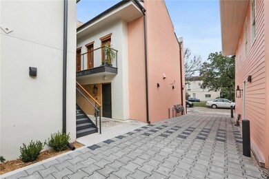 The driveway to the parking lot. Up the stairs and to the right is the unit.
