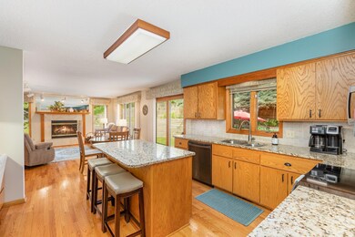 Kitchen with center island. Seats three and allows for more workspace and storage.