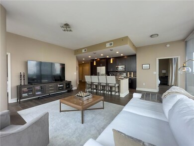 Living room with dark wood-style floors and basebo