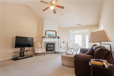 Living room featuring ceiling fan, carpet floors, 