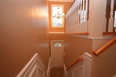 2 story entry with coat closet. Window and chandel