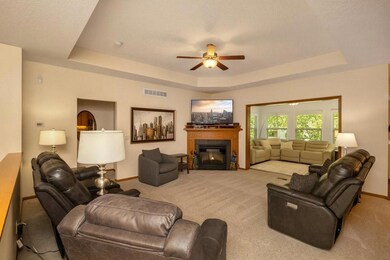 Main level living room w/ fireplace and a sunroom