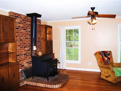 Livingroom w/ Wood Burning Stove. Natural Hardwood