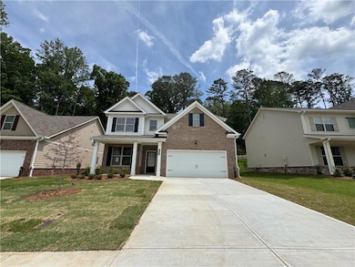 Craftsman house featuring concrete driveway, a front lawn, a porch, and brick siding