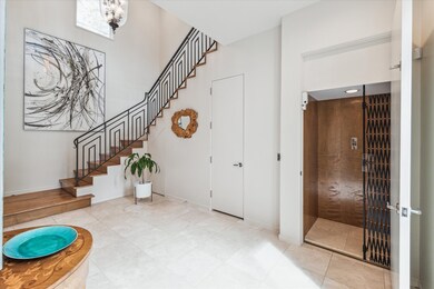 FOYER: attractive maple wood staircase & wrought iron railing.