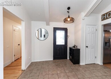 Entrance foyer with light tile patterned flooring 