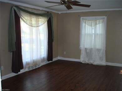 Ceiling fan and laminate wood floors in livingroom