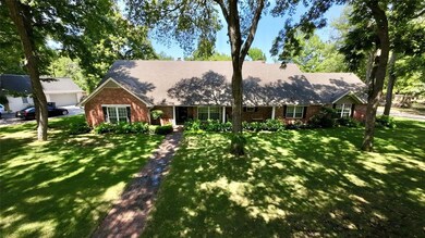 Front of the home with mature trees.