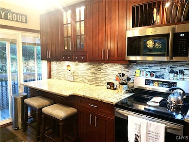 This kitchen features a breakfast bar, ...