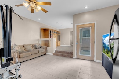 Living room with a ceiling fan, recessed lighting,
