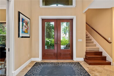Two story foyer with steps to upstairs bedrooms/ba