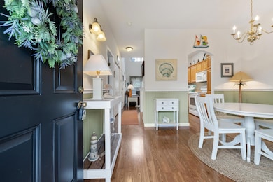 Entryway featuring a chandelier, wood finished flo