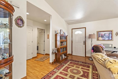 Entryway featuring light wood-style floors, recessed lighting, and a wall unit AC