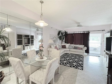 Dining area with ceiling fan and a textured ceilin