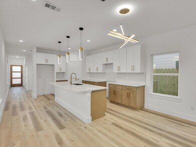 Kitchen with light wood-type flooring, a center is