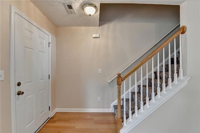 Entrance foyer with wood finished floors, a textur