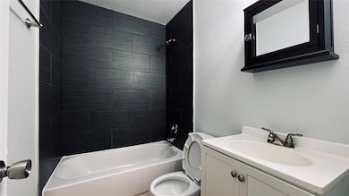 Bathroom with vanity and  shower combination