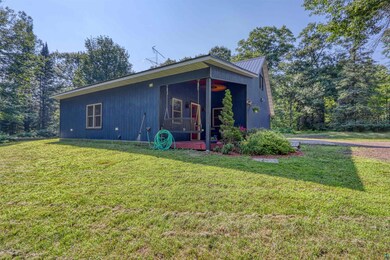 View of front of home featuring a front yard and a metal roof