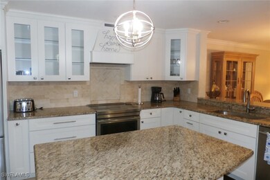 Kitchen with range, decorative backsplash, stone c