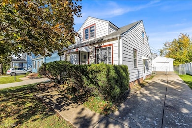 View of front of house featuring a garage and roof with shingles