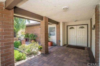 Stately double doors accented by large covered ent