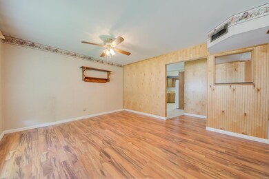 Laminate flooring in living room with ceiling fan 