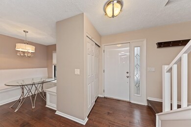 The gorgeous breakfast area features a built in banquette and chandelier and lots of natural light from the window.