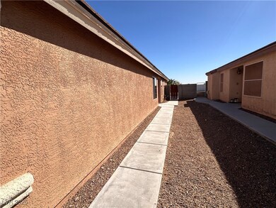 View of side of home with fence and stucco siding