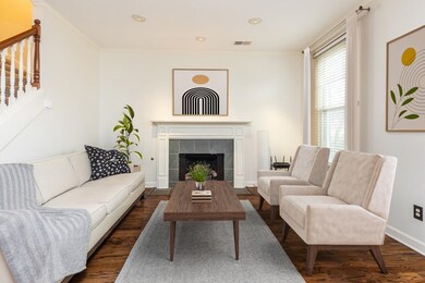 Living room with dark wood-type flooring, ornament