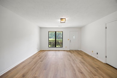 Empty room with light wood-style flooring and baseboards