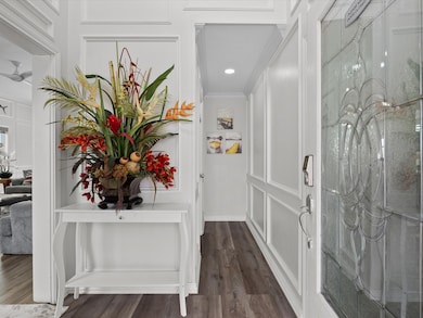 Elegant entryway with decorative paneling, a glass