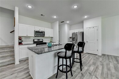 Kitchen with stainless steel appliances, a sink, a