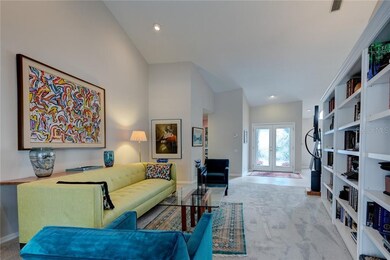 Interior front entry over looks formal living room with built in shelving.